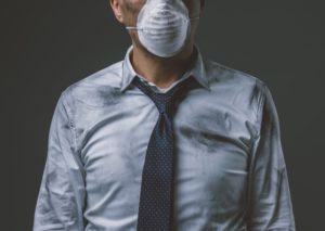 Businessman with mask and air pollution